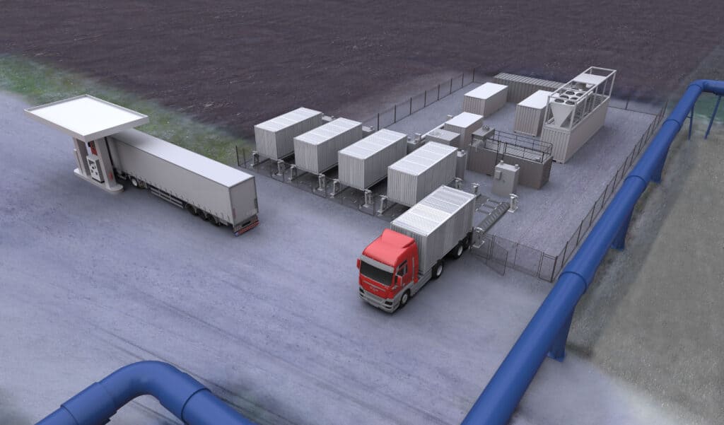 Vue aérienne de deux camions près d'une installation industrielle clôturée avec plusieurs unités de conteneurs blancs, à côté de grands pipelines bleus.
